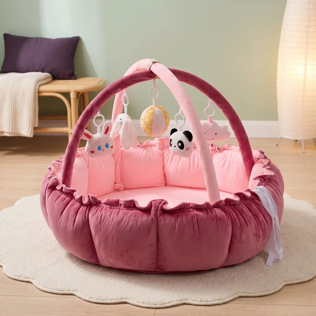 Rose baby play gym nest with soft hanging toys in a calm nursery