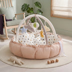 Peach baby play gym nest with heart print cushions and hanging star, cloud and moon toys
