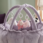 Close-up of the soft hanging toys on the lavender play gym arch
