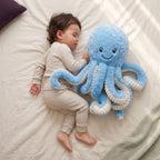 Toddler sleeping beside a large blue octopus soft toy with curly tentacles