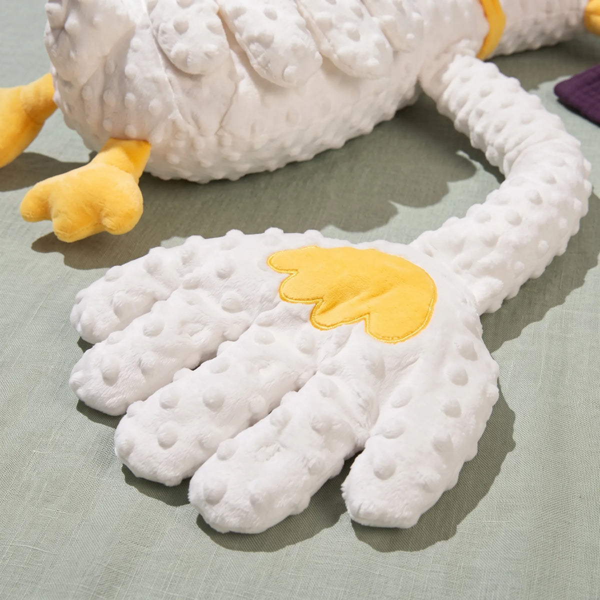 Close-up of the soft dotted fleece patting hand with yellow embroidered detail